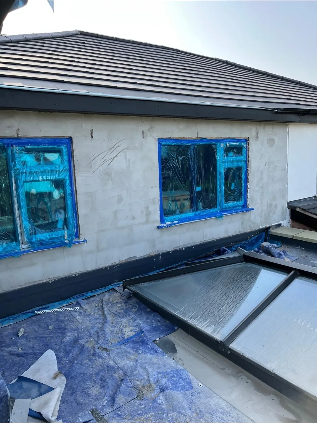 External works in progress with windows masked and blockwork exposed