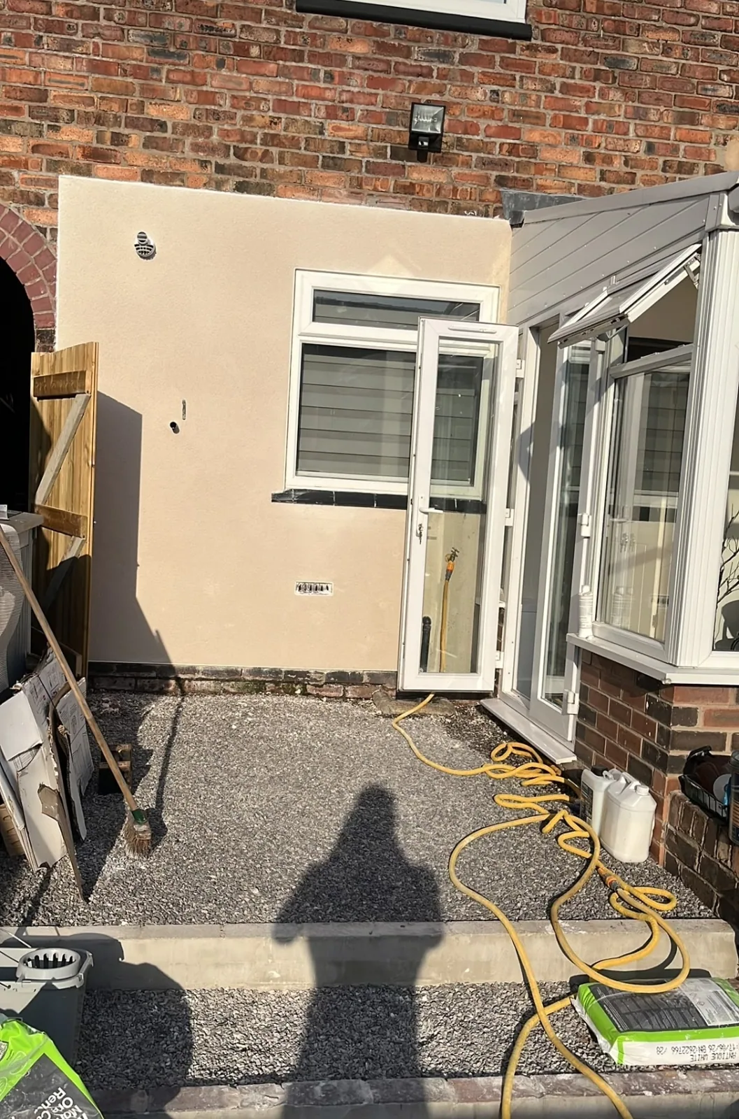 Completed smooth exterior render on the rear elevation