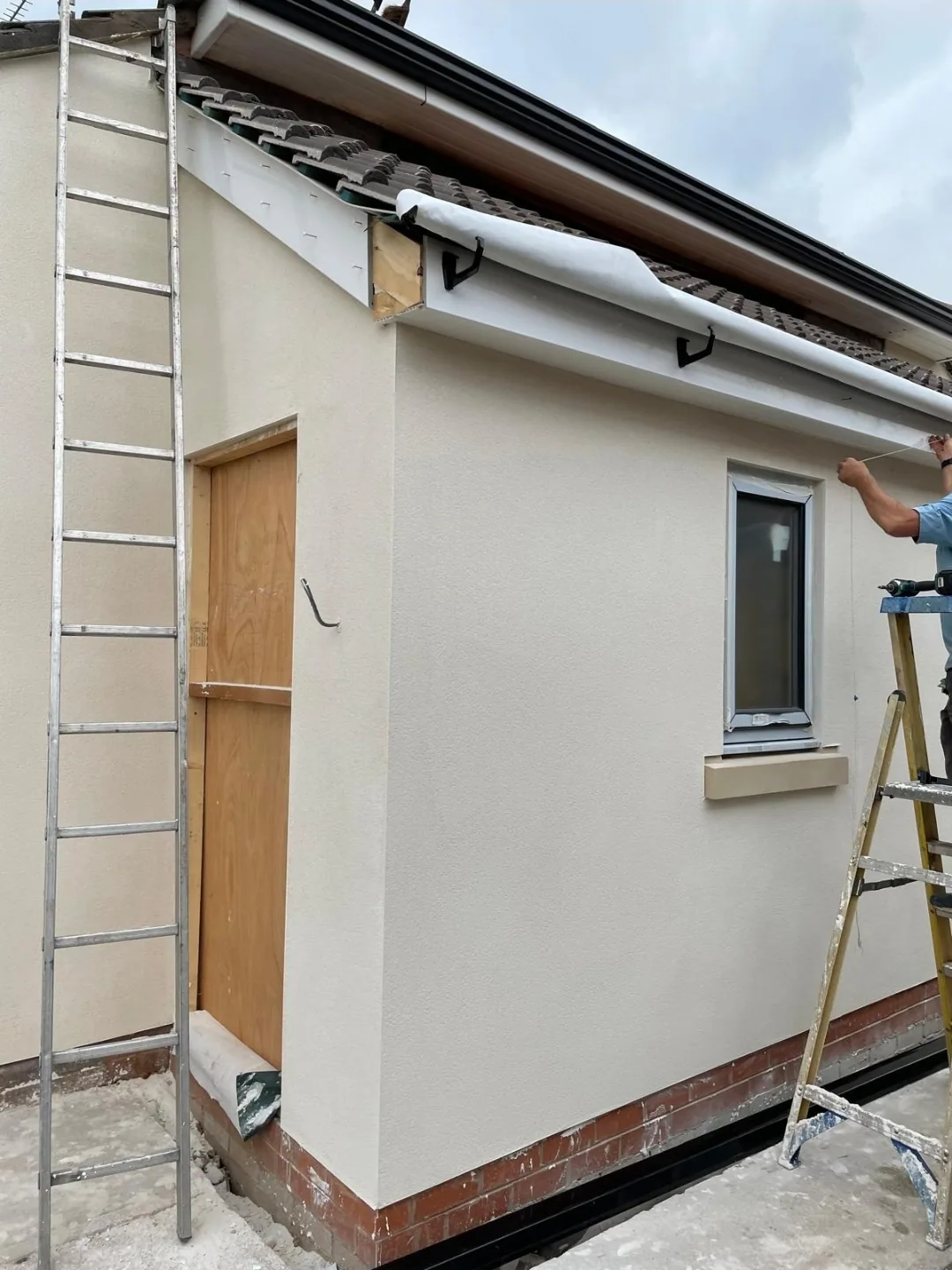 Render being applied to an extension wall