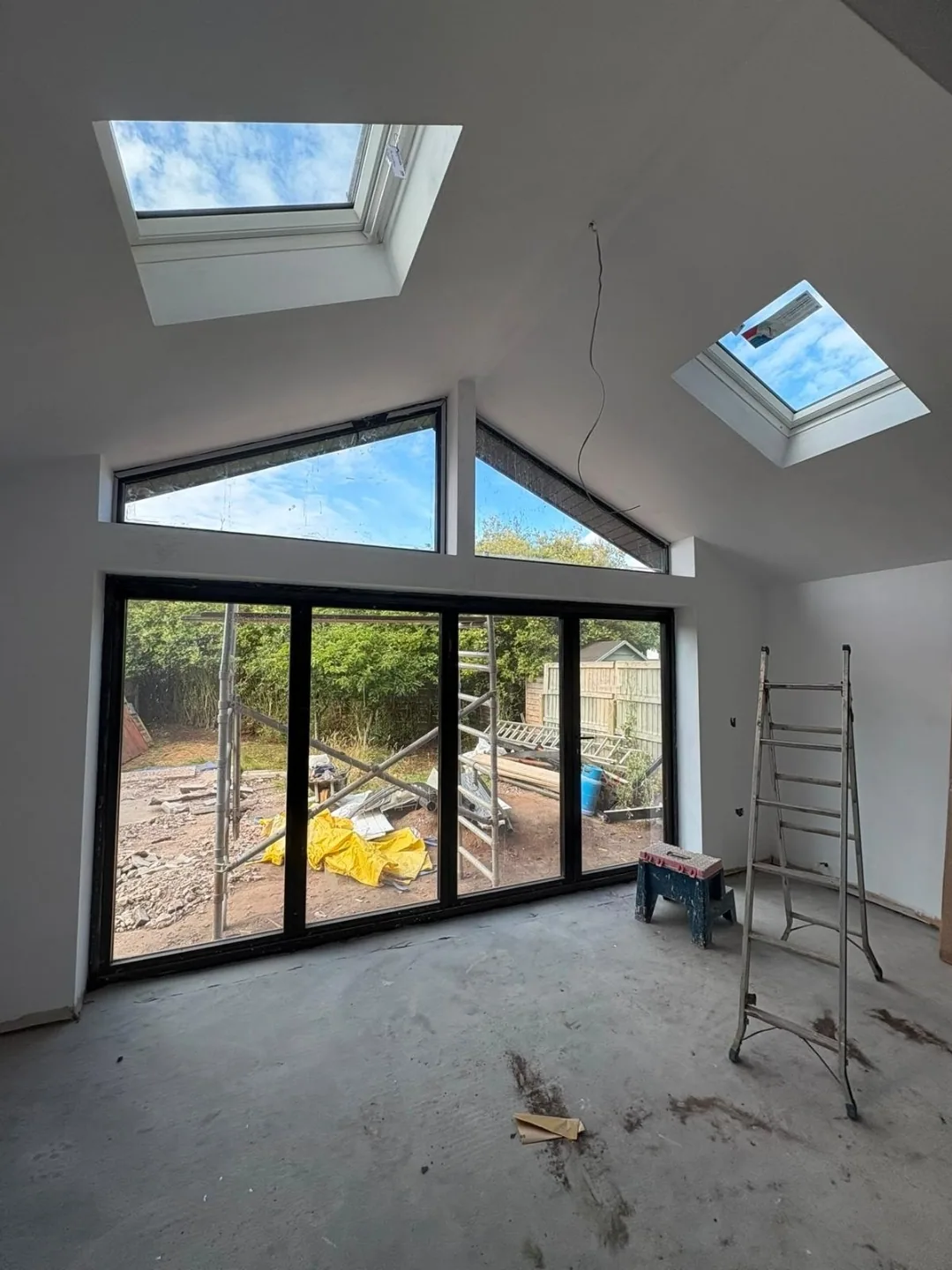 Completed extension interior with vaulted ceiling and full-height glazing