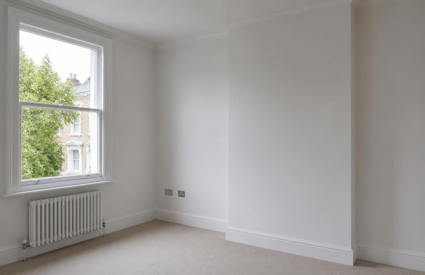 Room after replastering with smooth white walls